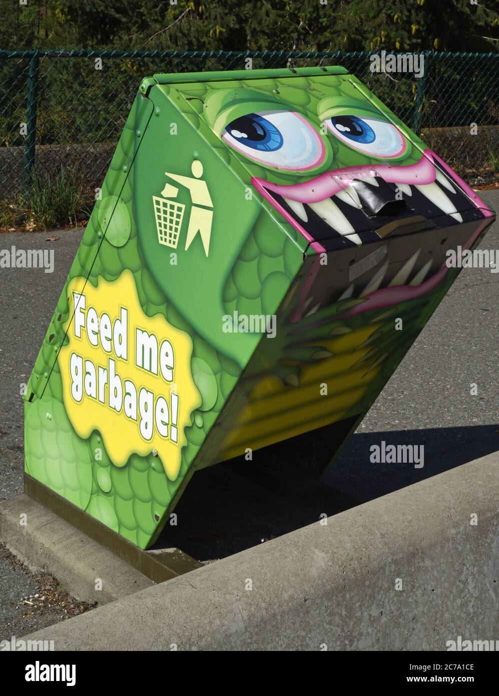 A garbage can painted to look like a cartoon type monster located at a highway rest stop on Vancouver Island, British Columbia, Canada. On the side it Stock Photo