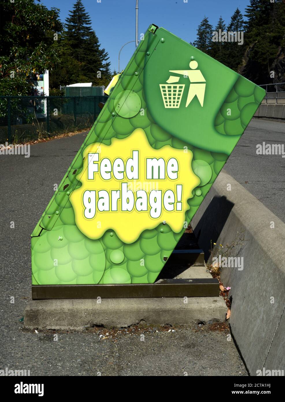 A garbage can painted to look like a cartoon type monster located at a highway rest stop on Vancouver Island, British Columbia, Canada. On the side it Stock Photo