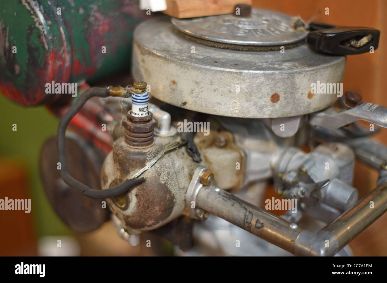 Detail of a 1931 Johnson 3 horsepower outboard boat motor including the sparkplug on display at