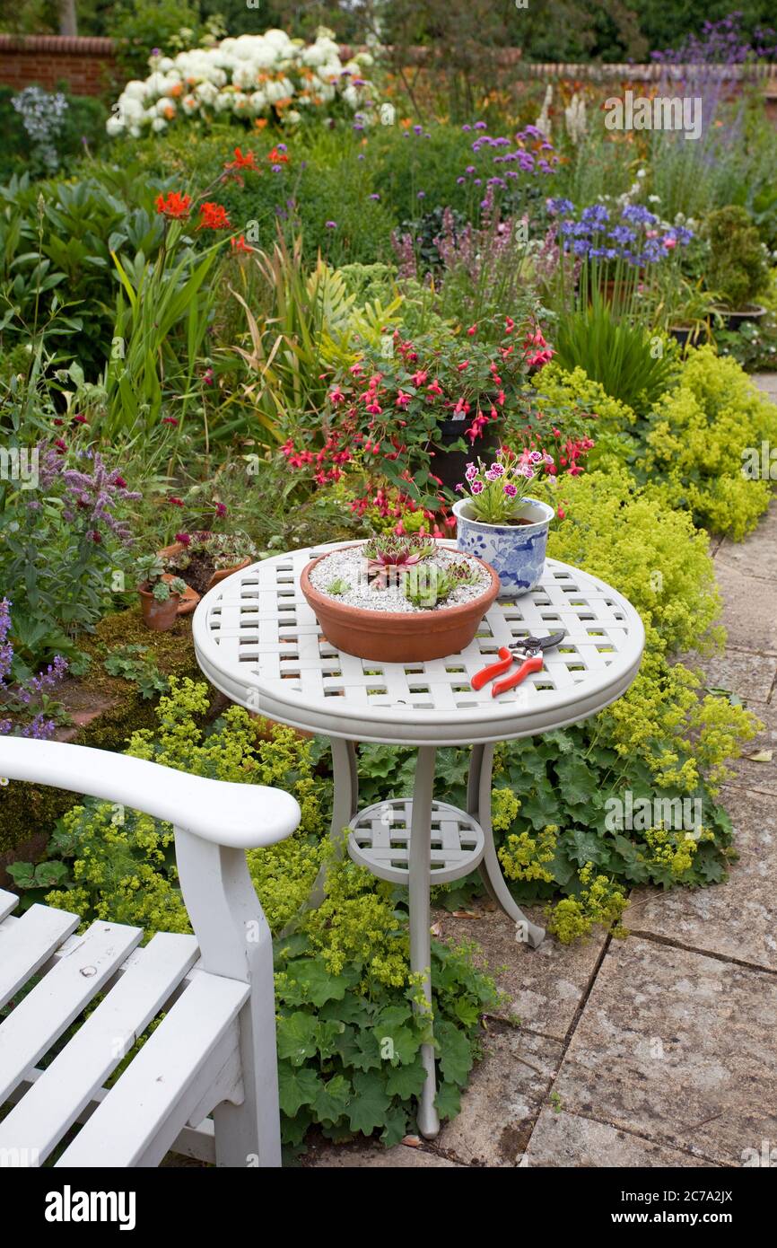 Garden bench and table on patio. England Stock Photo