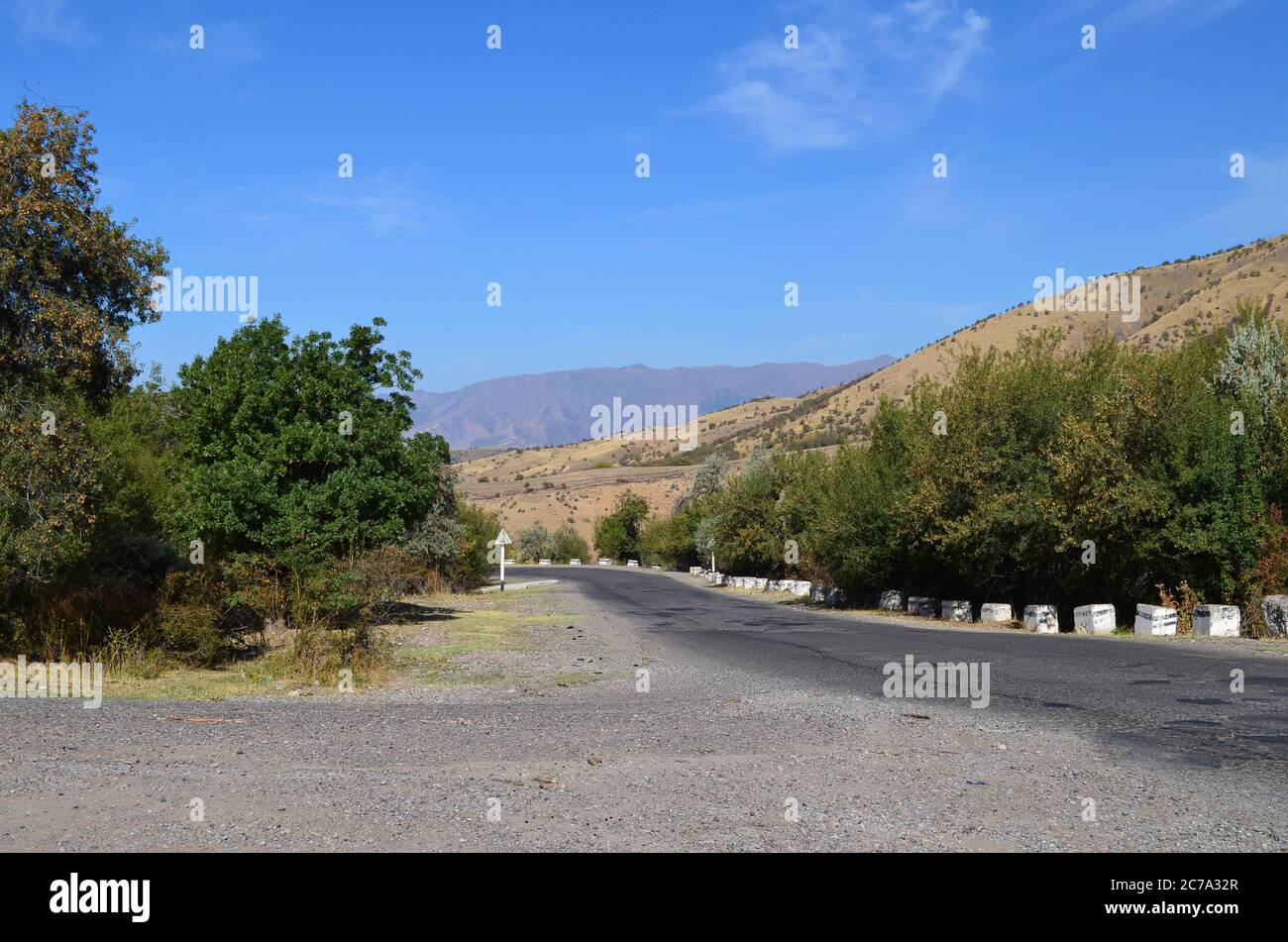 Empty paved road in the mountains of Uzbekistan for cars. Beldersay. Stock Photo