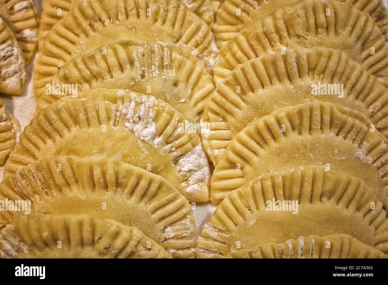 Rows of uncooked pierogies waiting to be fried. Stock Photo