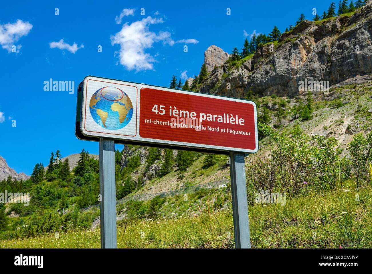 Red sign with globe indicating the 45th parallel in the French Alps, near Briançon Stock Photo