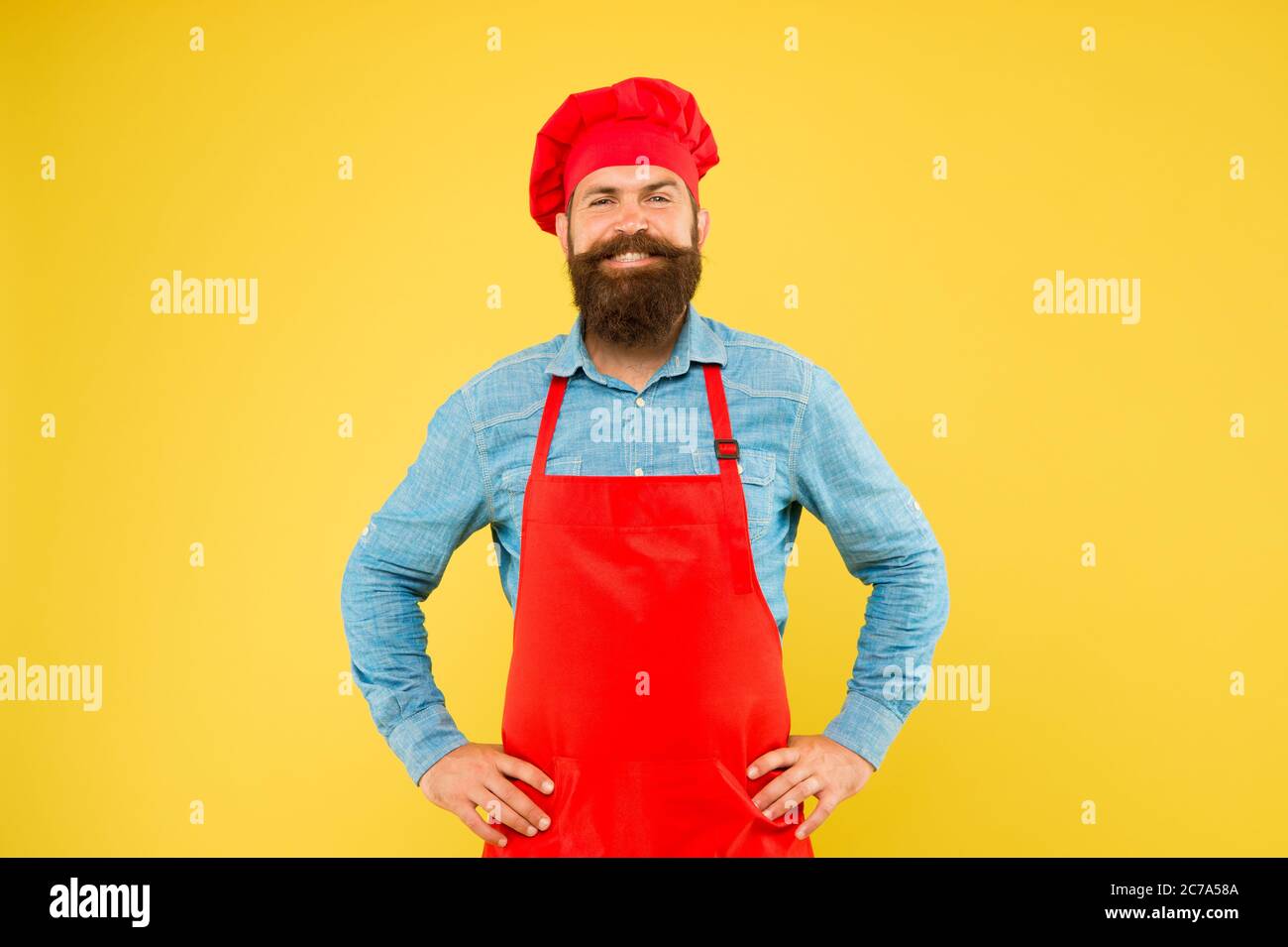 Excellent Cook mature male chef on yellow backdrop. man cooking on kitchen ...