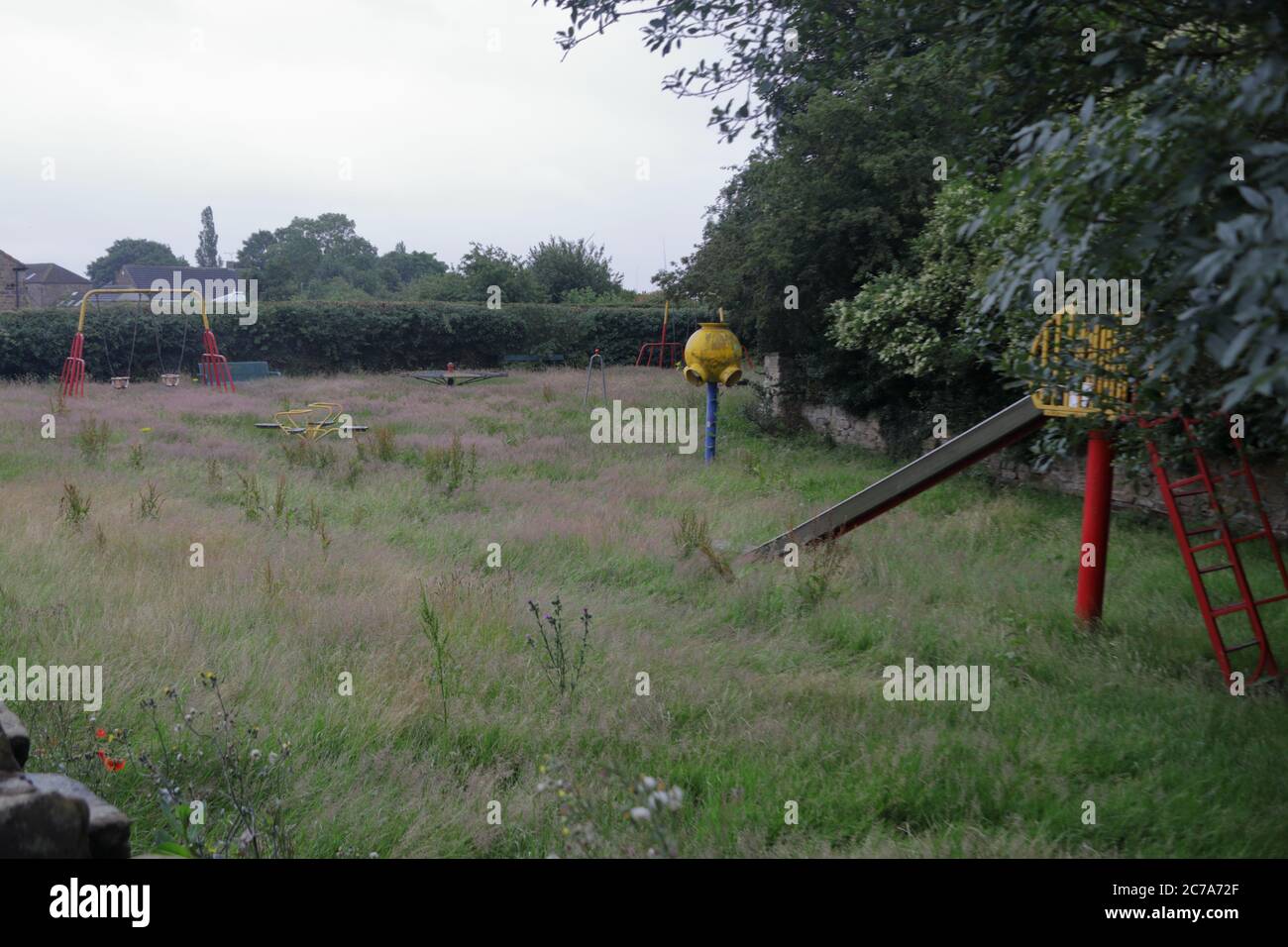 an overgrown childrens playground that has been closed since March 2020 due to covid19 Stock Photo