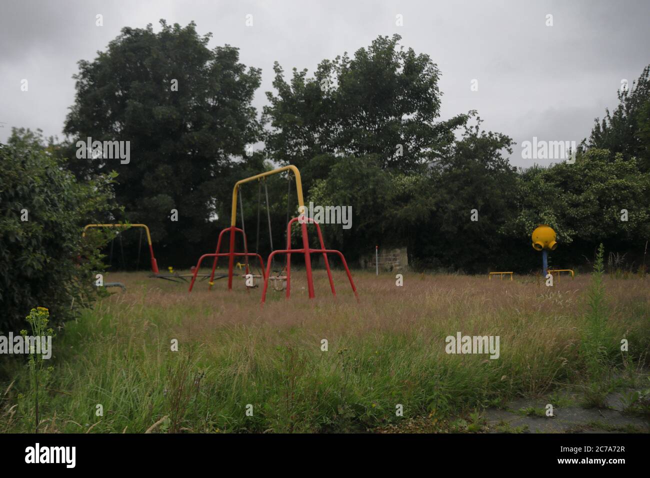 an overgrown childrens playground that has been closed since March 2020 due to covid19 Stock Photo