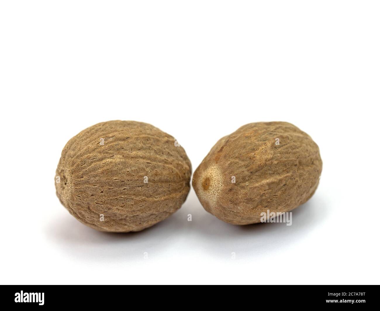 Nutmegs isolated against a white background Stock Photo