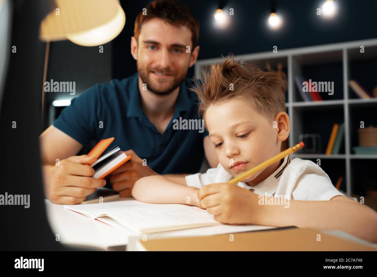Father helping his little son with school homework Stock Photo - Alamy