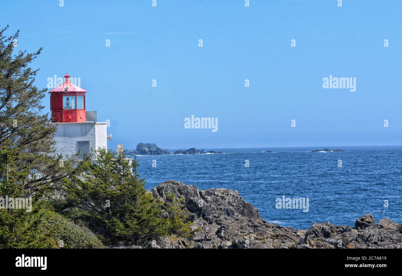 Amphitrite Point Lighthouse looking out to the Pacific Ocean, against a clear, blue, summer sky Stock Photo