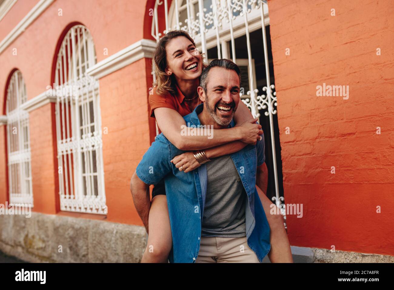 Woman carrying man on back hi-res stock photography and images - Alamy