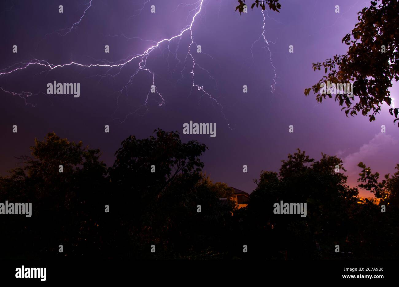 Lightning strikes between stormy clouds above a residential area Stock Photo Alamy