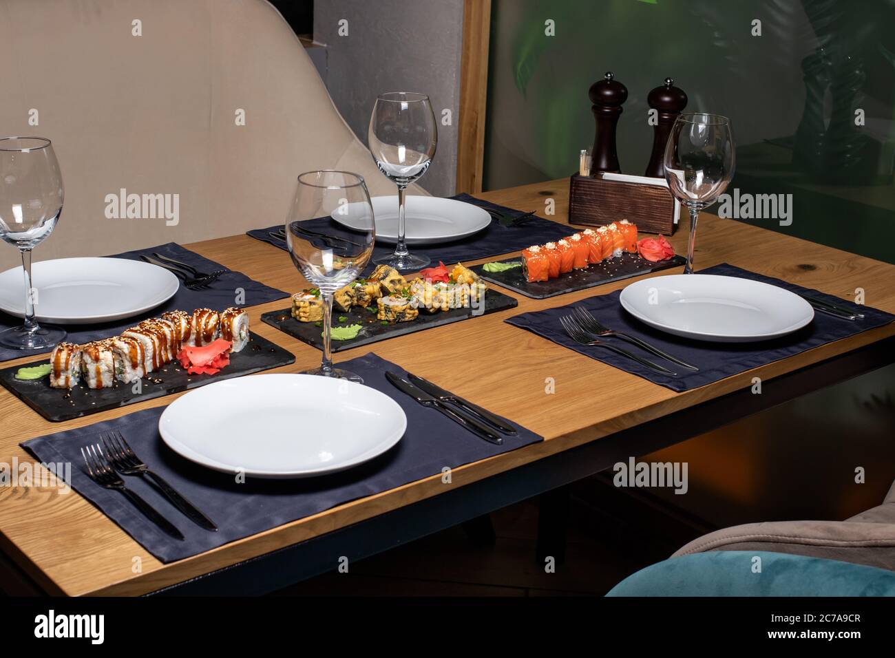Sushi on the table in the restaurant. Served table with plates and glasses. It's a beautiful serve. Stock Photo