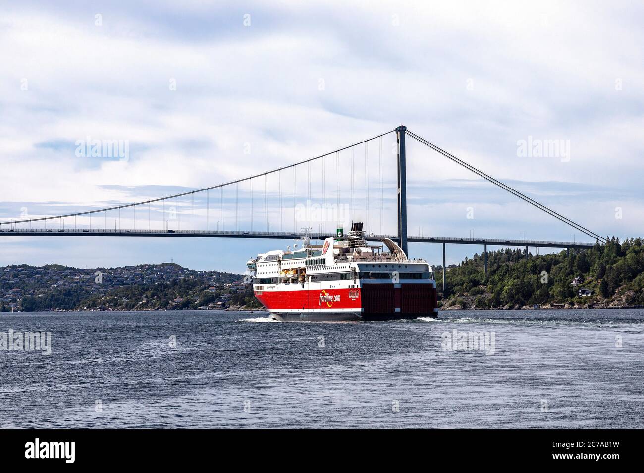 Ro-ro / passenger ship Stavangerfjord departing from the port ofBergen, Norway. Approaching the Askoey suspension bridge Stock Photo