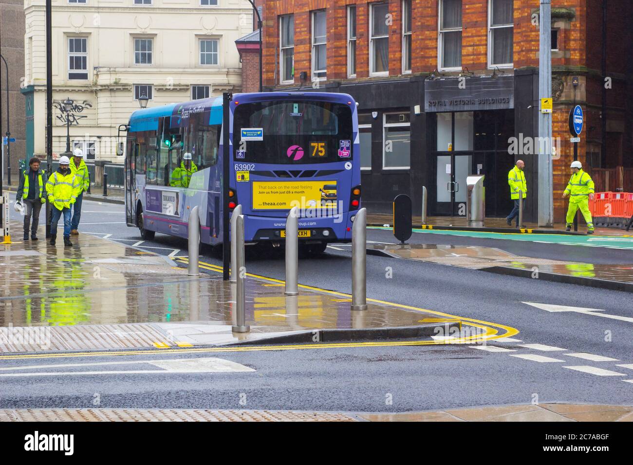 8 July 2020 Workmen wearing hi visibility clothing and hard hats on Bridge Street in empty downtown Sheffield England during the Covid 19 crisis. Stock Photo