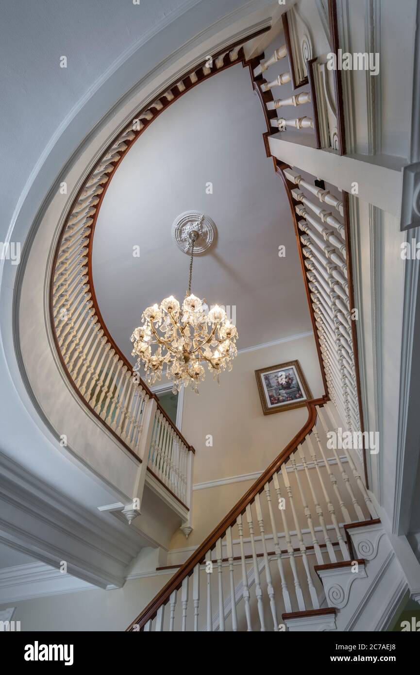 Looking up elegant curved staircase in residential home Stock Photo