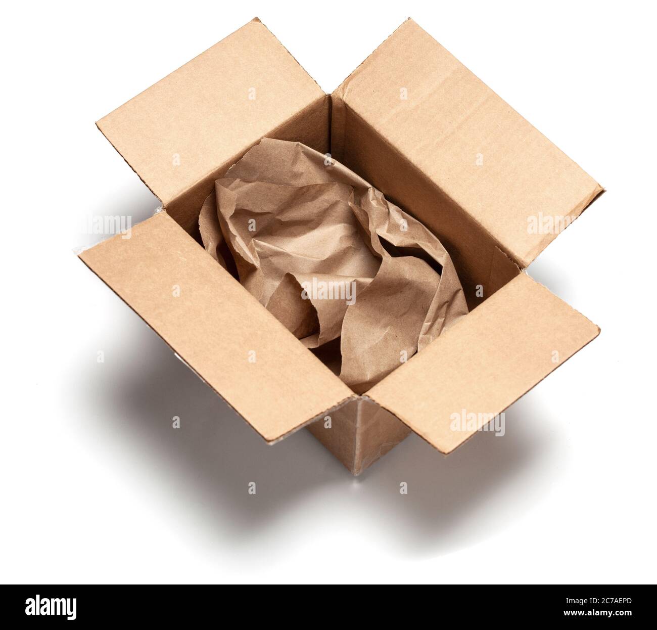 Open cardboard box with wrapping paper inside. Isolated on a white