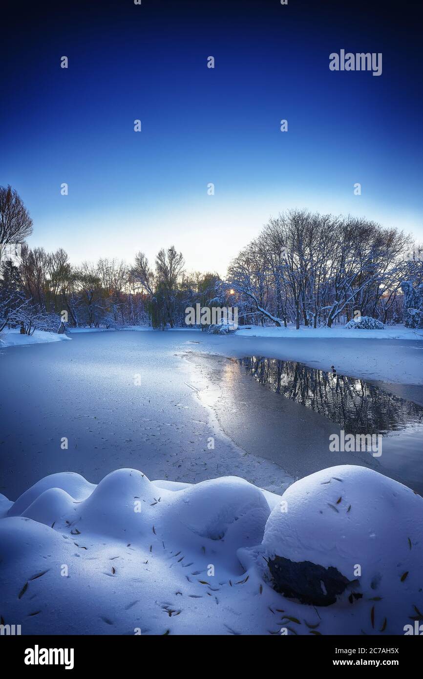 Winter landscape by a frozen river. Mirror reflection Stock Photo - Alamy