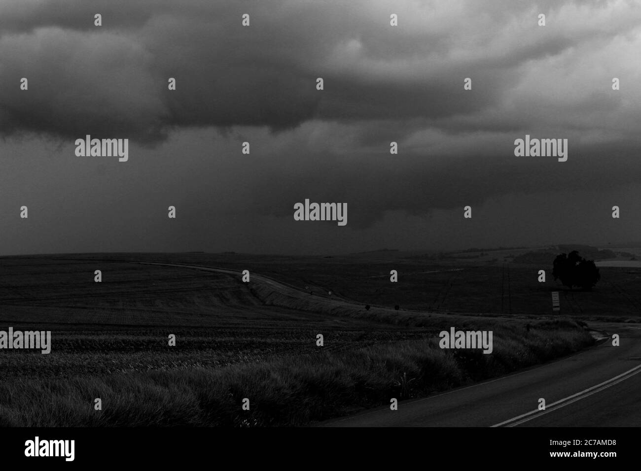 Storm clouds over the field and road Stock Photo - Alamy