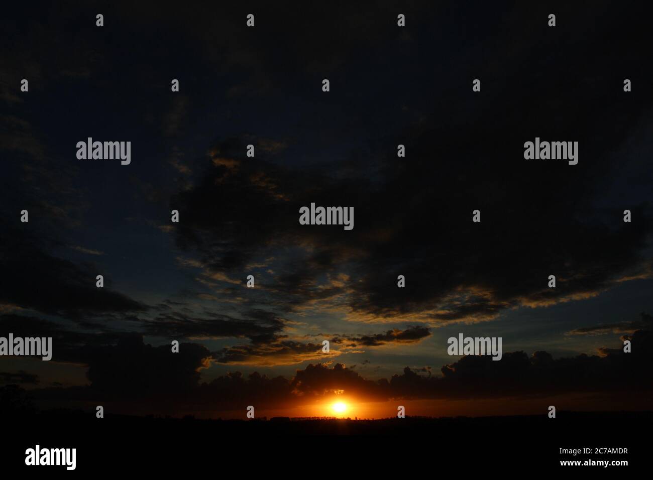 Dark clouds at sunset Stock Photo