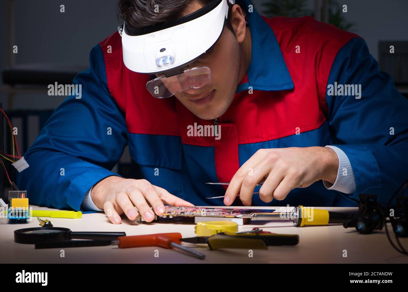 The computer specialist repairing pc late at night Stock Photo - Alamy
