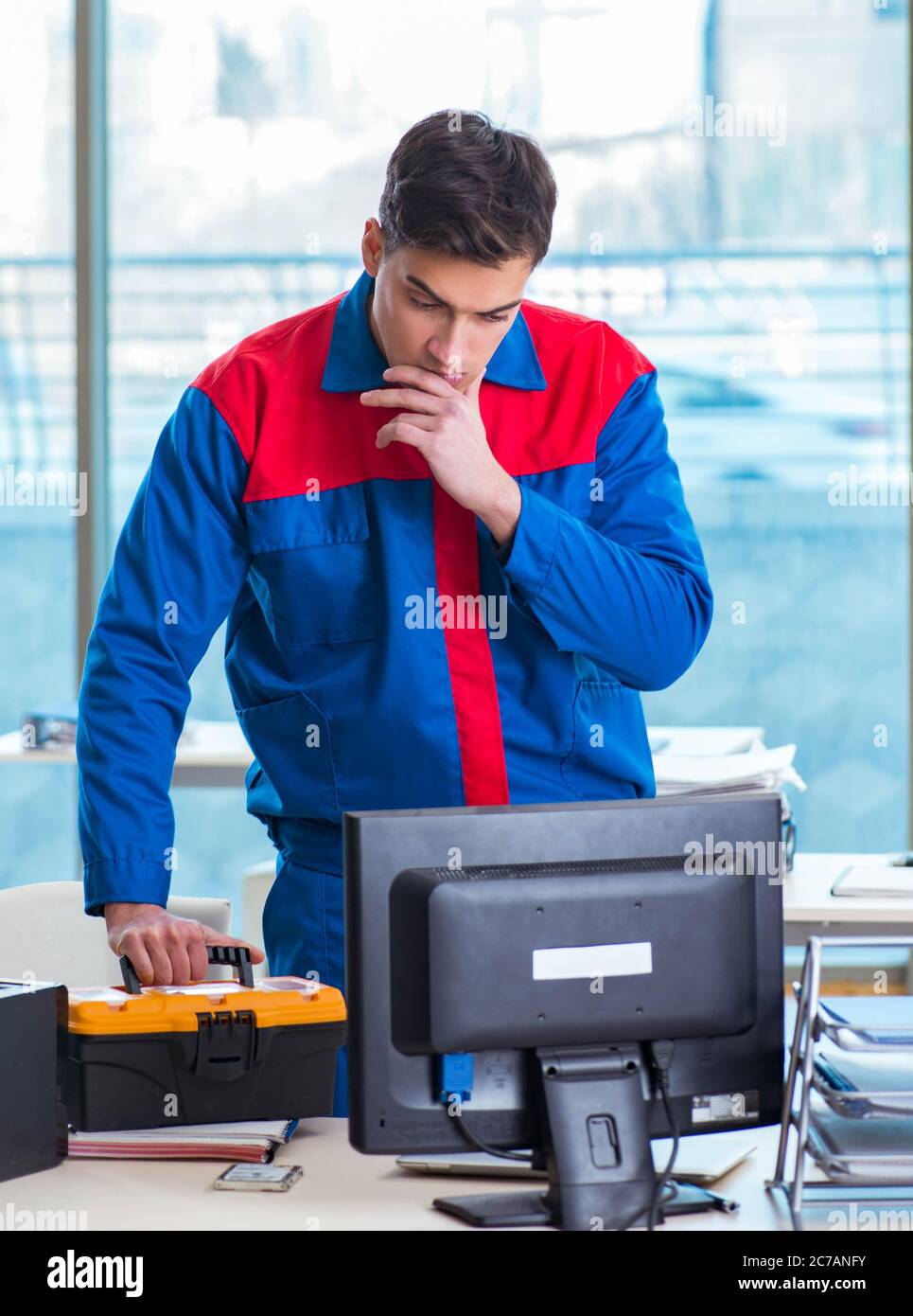 The computer technician repairing broken computer in workshop Stock ...