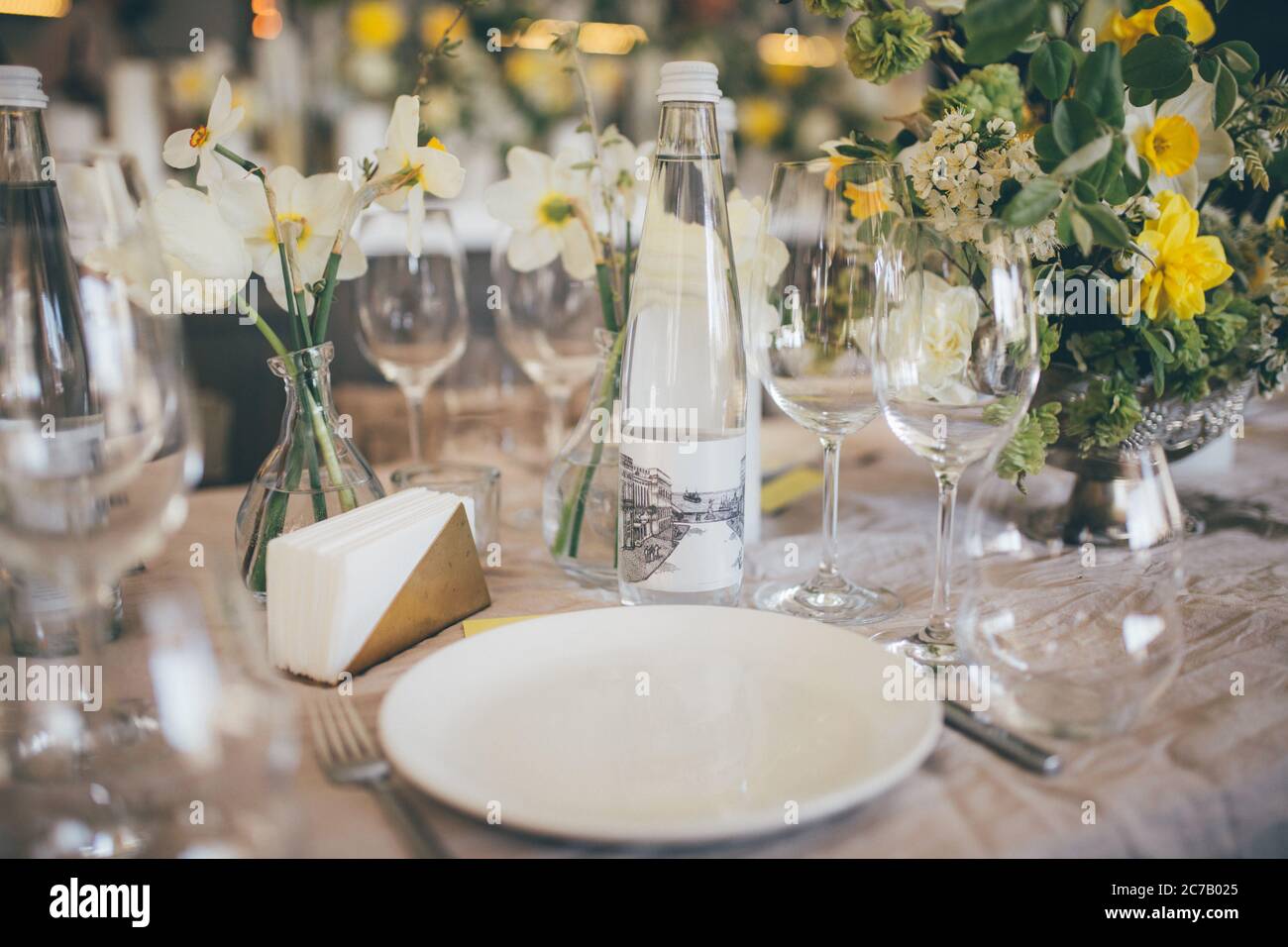 Beautiful served wedding table with decor as candles, flower arrangements. Banquet dinner party. Wine glasses, water Stock Photo