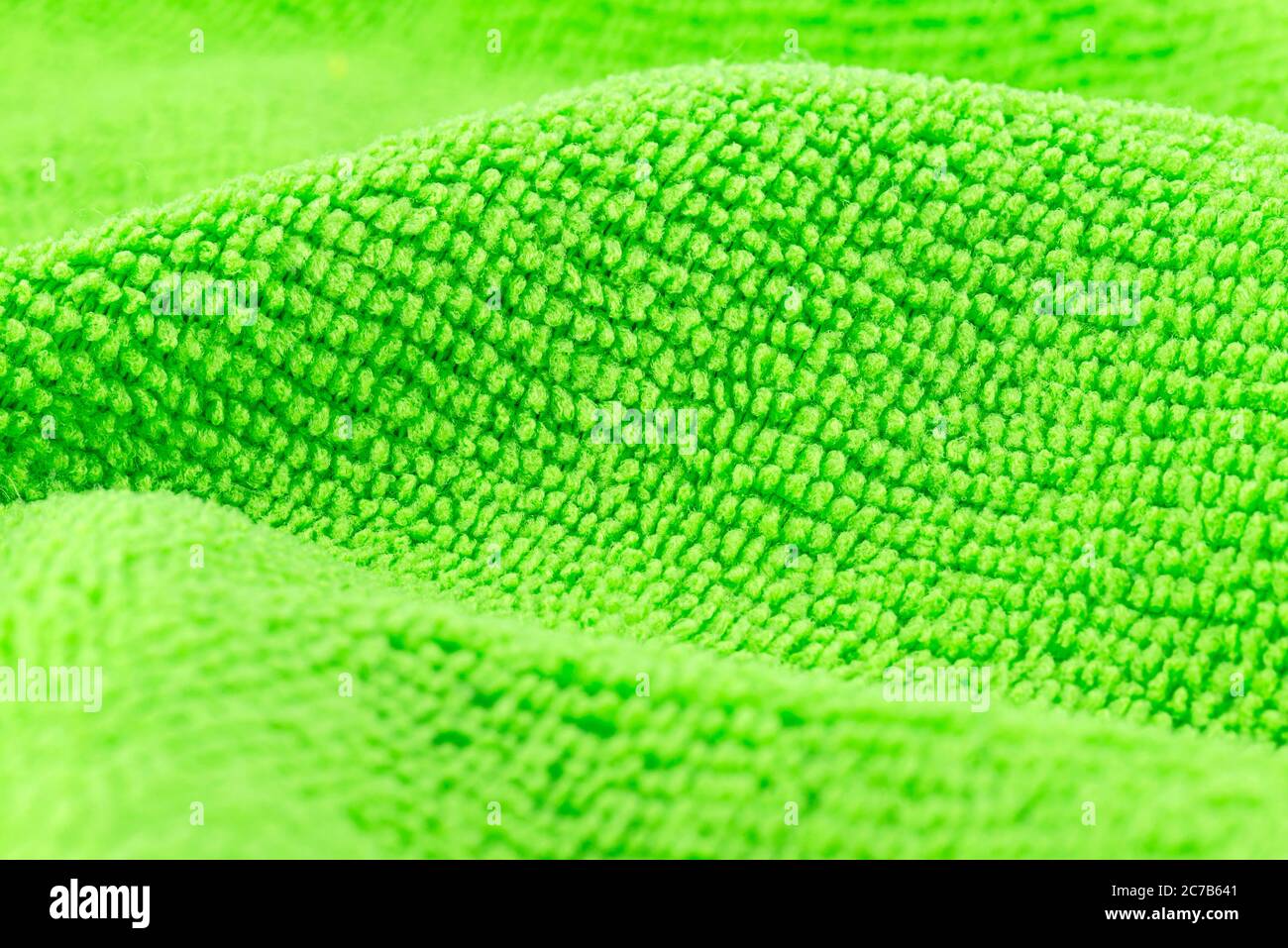 Background made of green microfiber fabric, selective focus. Stock Photo