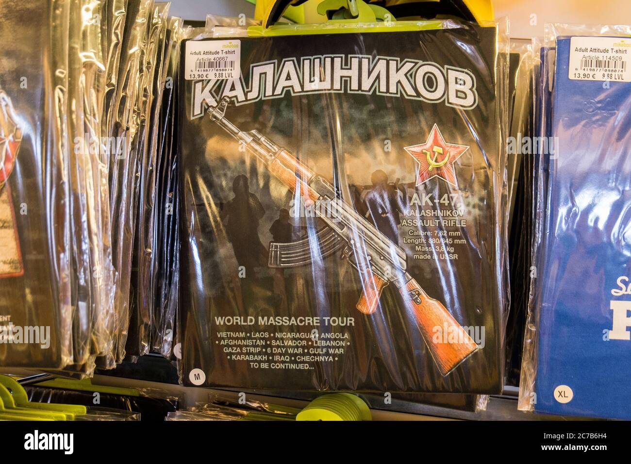 Detail of a T-Shirt for sale that features the famous Russian Kalashnikov assualt rifle. In the Duty Free shop on the Tallink ferry boat from Riga, La Stock Photo