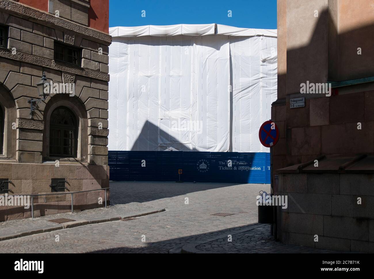 An old building is completely wrapped in white cloth while under restoration, renovation. In Stockholm, Sweden. Stock Photo