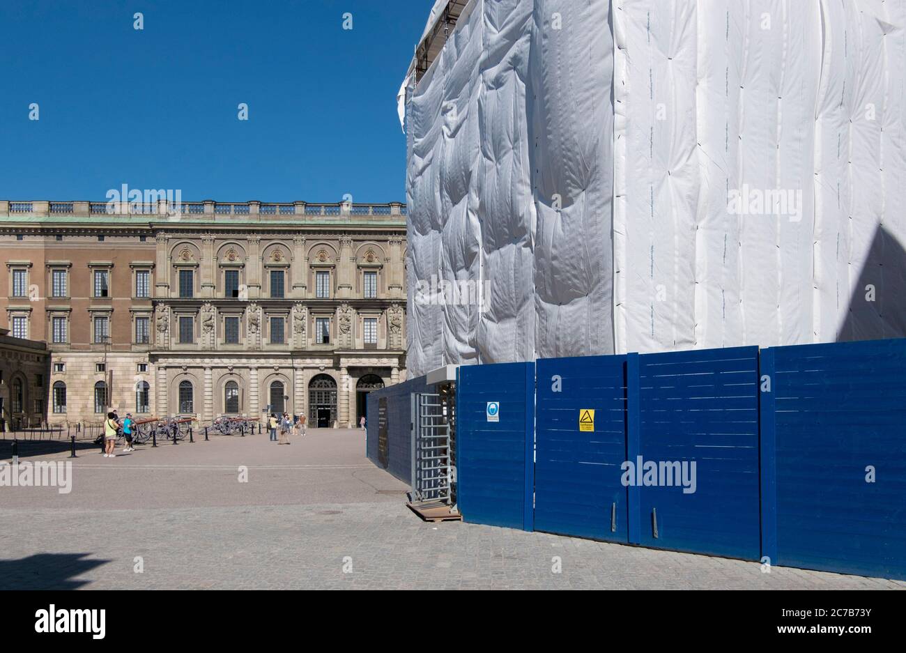 An old building is completely wrapped in white cloth while under restoration, renovation. In Stockholm, Sweden. Stock Photo