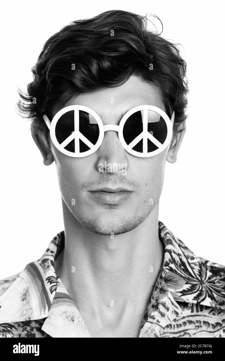 Face of young handsome man wearing sunglasses with peace sign Stock Photo