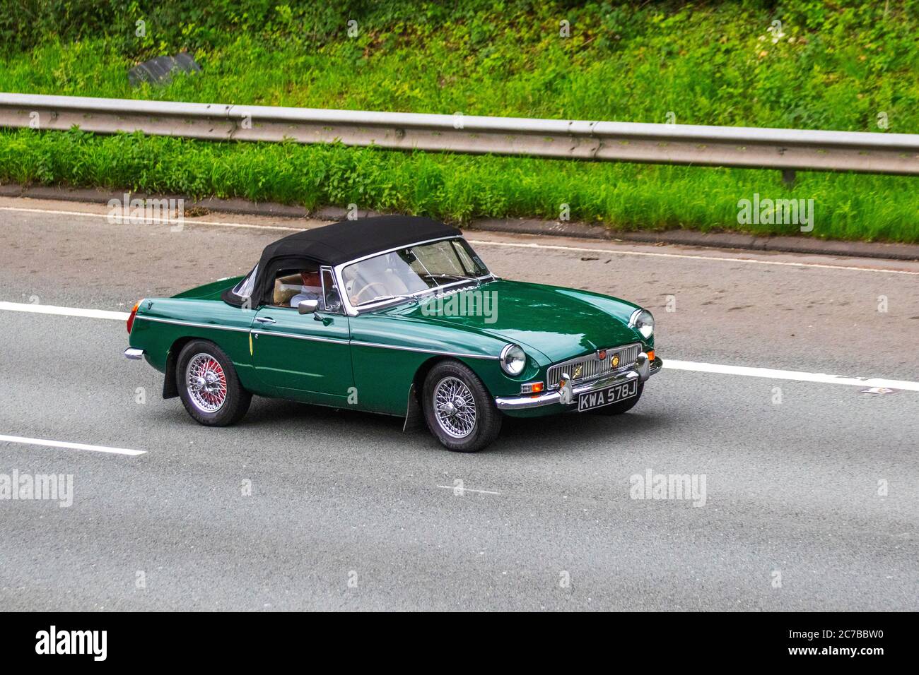 1971 70s seventies Green MG B 1798cc petrol; Vehicular traffic moving vehicles, cars driving vehicle on UK roads, 70s motors, sports cars motoring on the M6 motorway highway network. Stock Photo