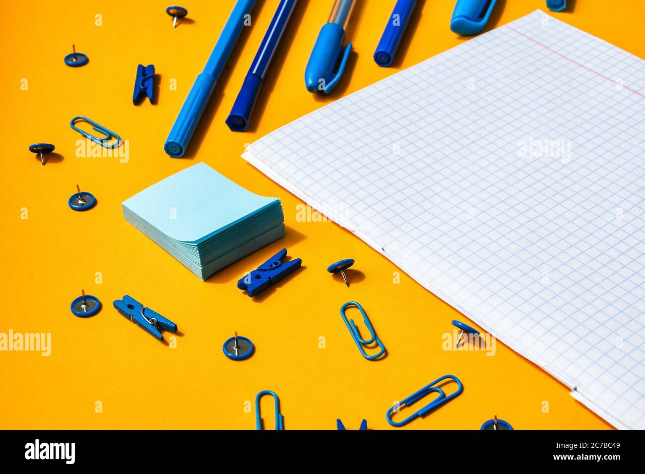 white squared paper from notebooks, wooden colored clothespin, paper