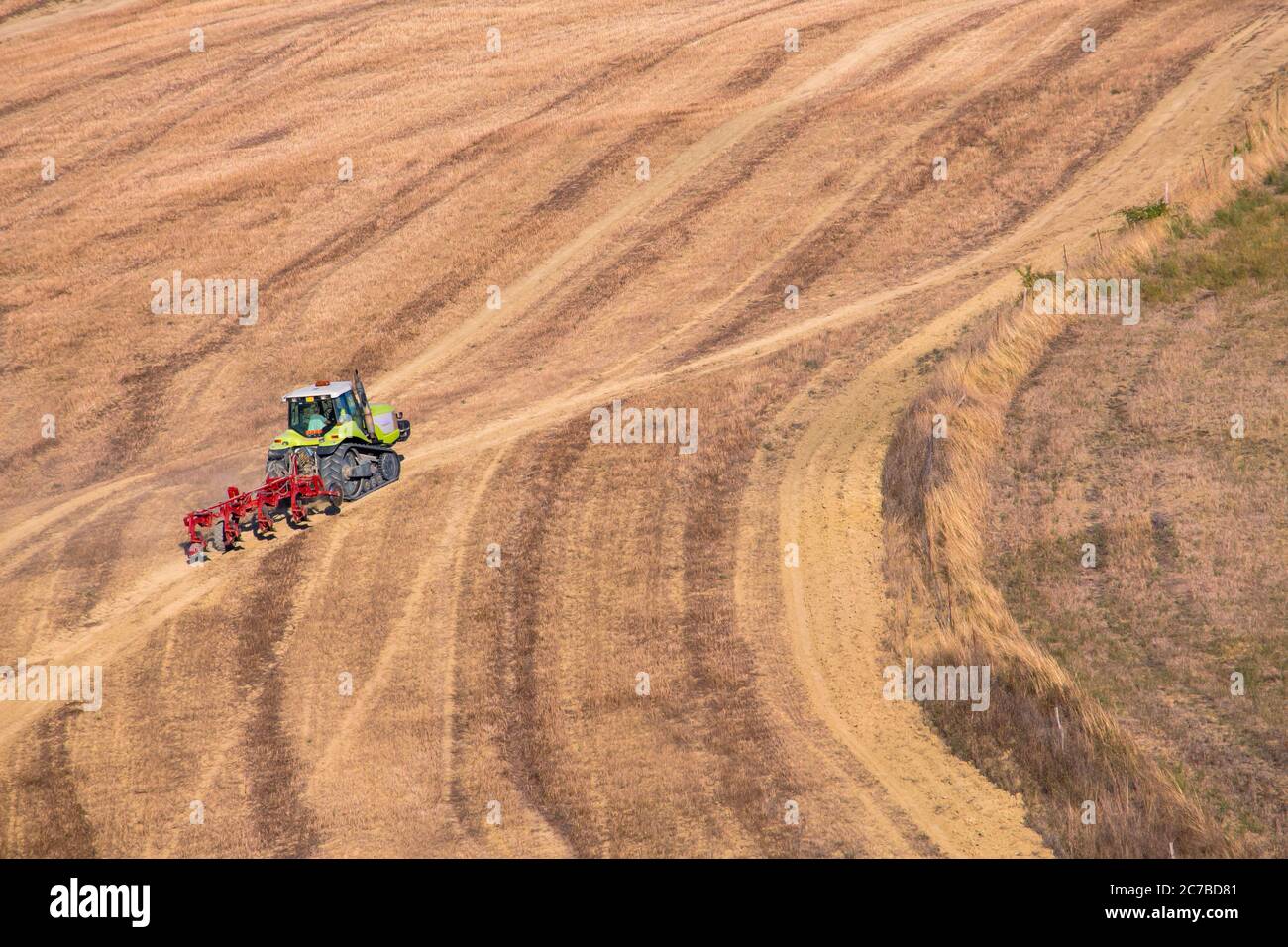 A farmer plowing the fields taken in Tuscany Italy with copy space. Stock Photo