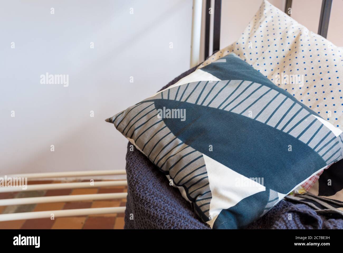 linen pillows with a geometric pattern lie on a plaid Stock Photo