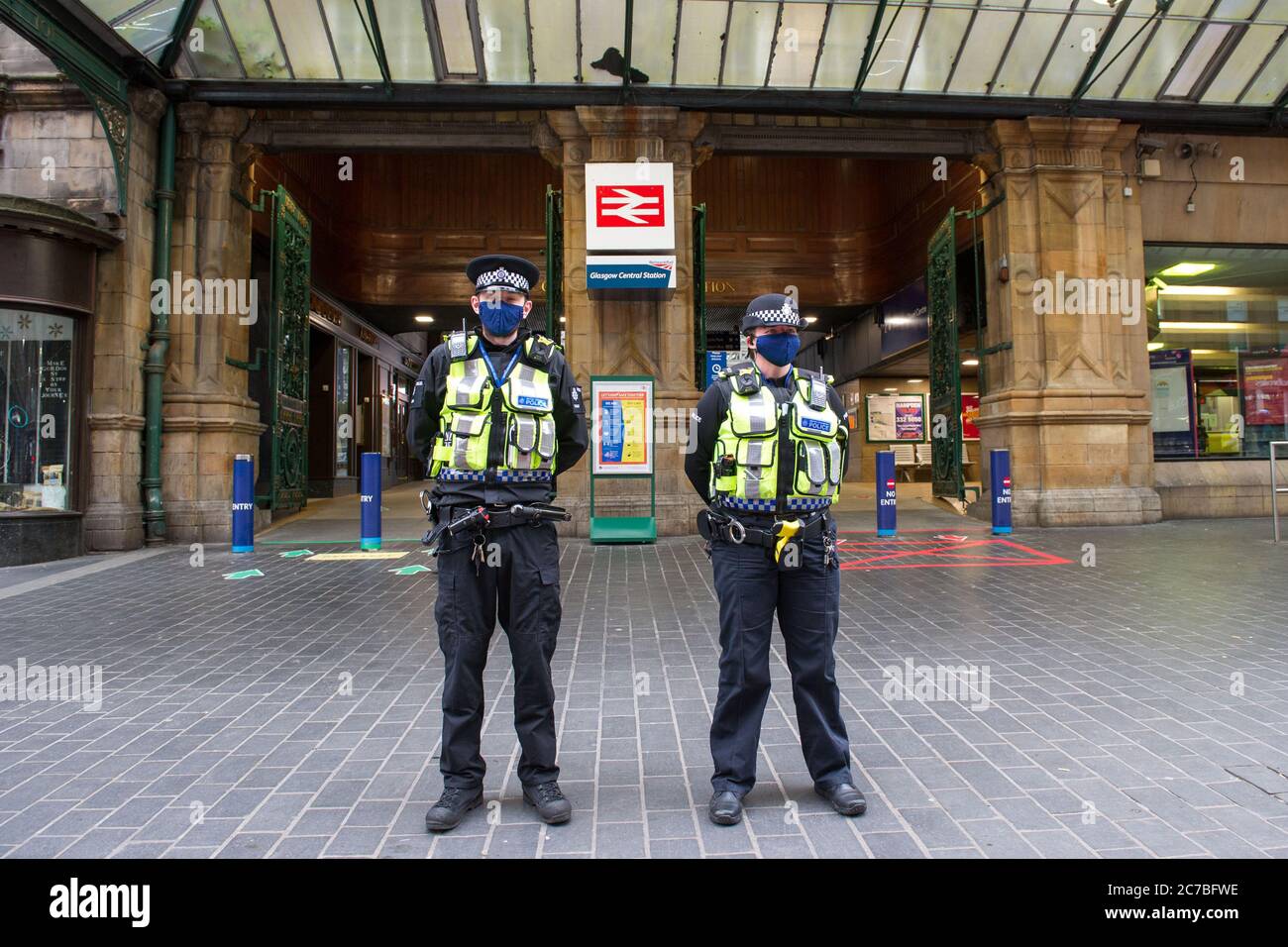 Glasgow, Scotland, UK. 16th July, 2020. Pictured: Police officers from Police Scotland seen wearing black face masks whilst on duty patrolling Glasgow Central Station. The Scottish Government made it mandatory that face coverings are worn when travelling on public transport in Scotland to help prevent the spread of coronavirus. Credit: Colin Fisher/Alamy Live News Stock Photo