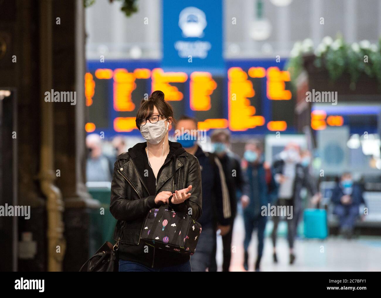 Glasgow, Scotland, UK. 16th July, 2020. Pictured: People wearing face masks and face coverings during their daily train commute at Central Station in the city centre. The Scottish Government made it mandatory that face coverings are worn when travelling on public transport in Scotland to help prevent the spread of coronavirus. Credit: Colin Fisher/Alamy Live News Stock Photo