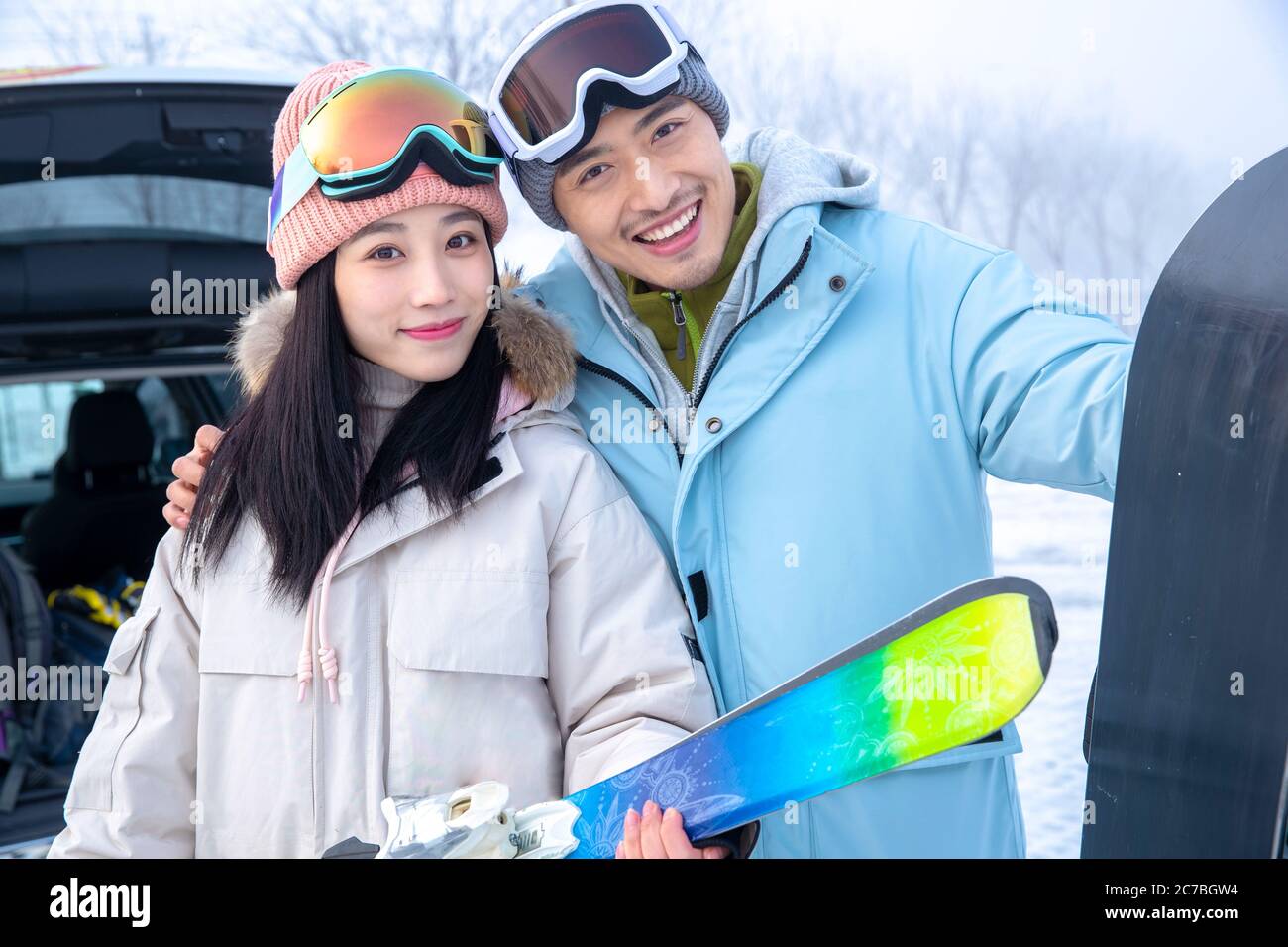 Happy young couples with skis hug together Stock Photo