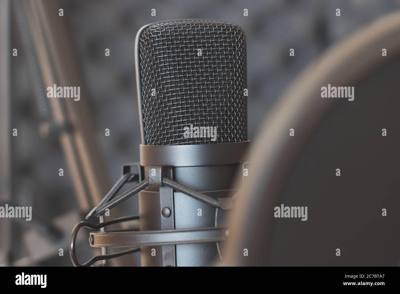 Studio dynamic microphone on a stand with a pop filter. Sound recording.  Streaming Stock Photo - Alamy