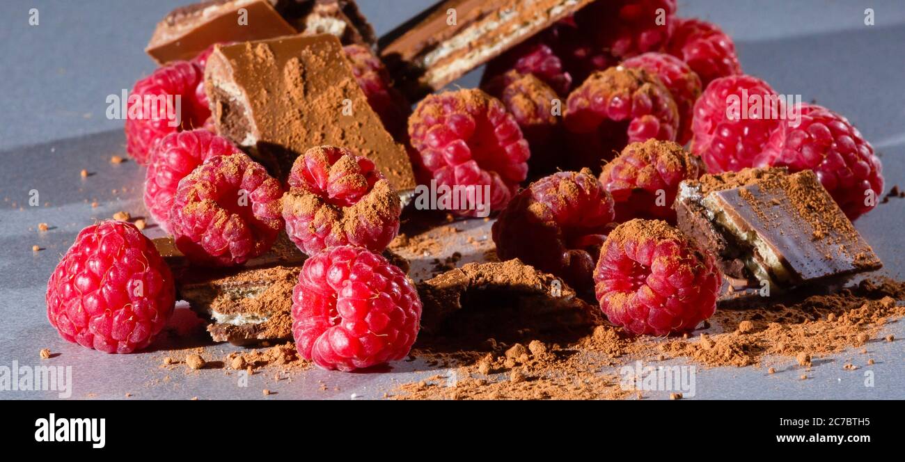 raspberries with chocolate on gray background chocolate Stock Photo - Alamy