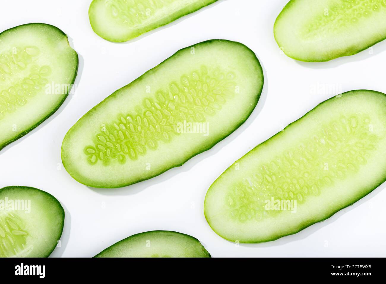 Cucumber slices pattern isolated on white background. Cucumis sativus background Stock Photo
