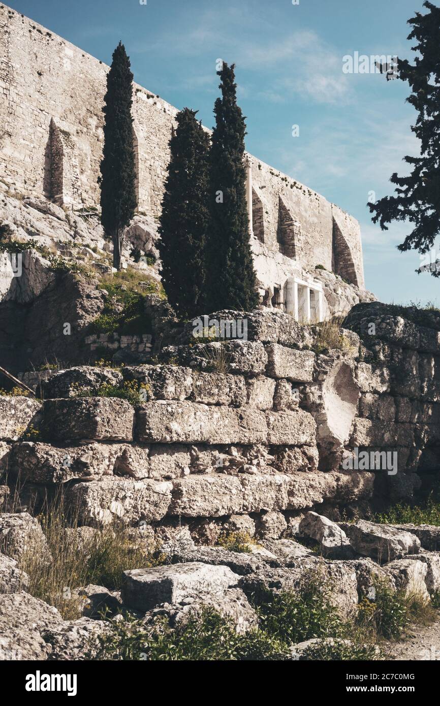 Vertical low angle shot of an old building with green trees under the ...