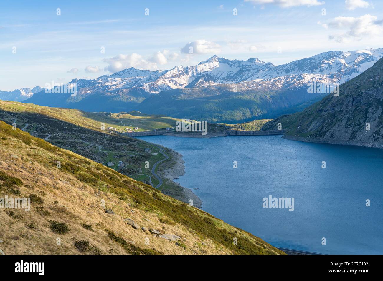 Montespluga lake with snow capped mountains in background, Madesimo, Valchiavenna, Valle Spluga, Valtellina, Lombardy, Italy Stock Photo