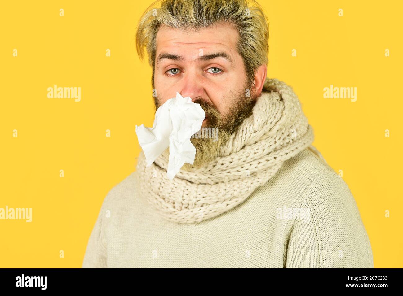 hipster sneezing and blow out nose. Allergy reaction. inflammatory