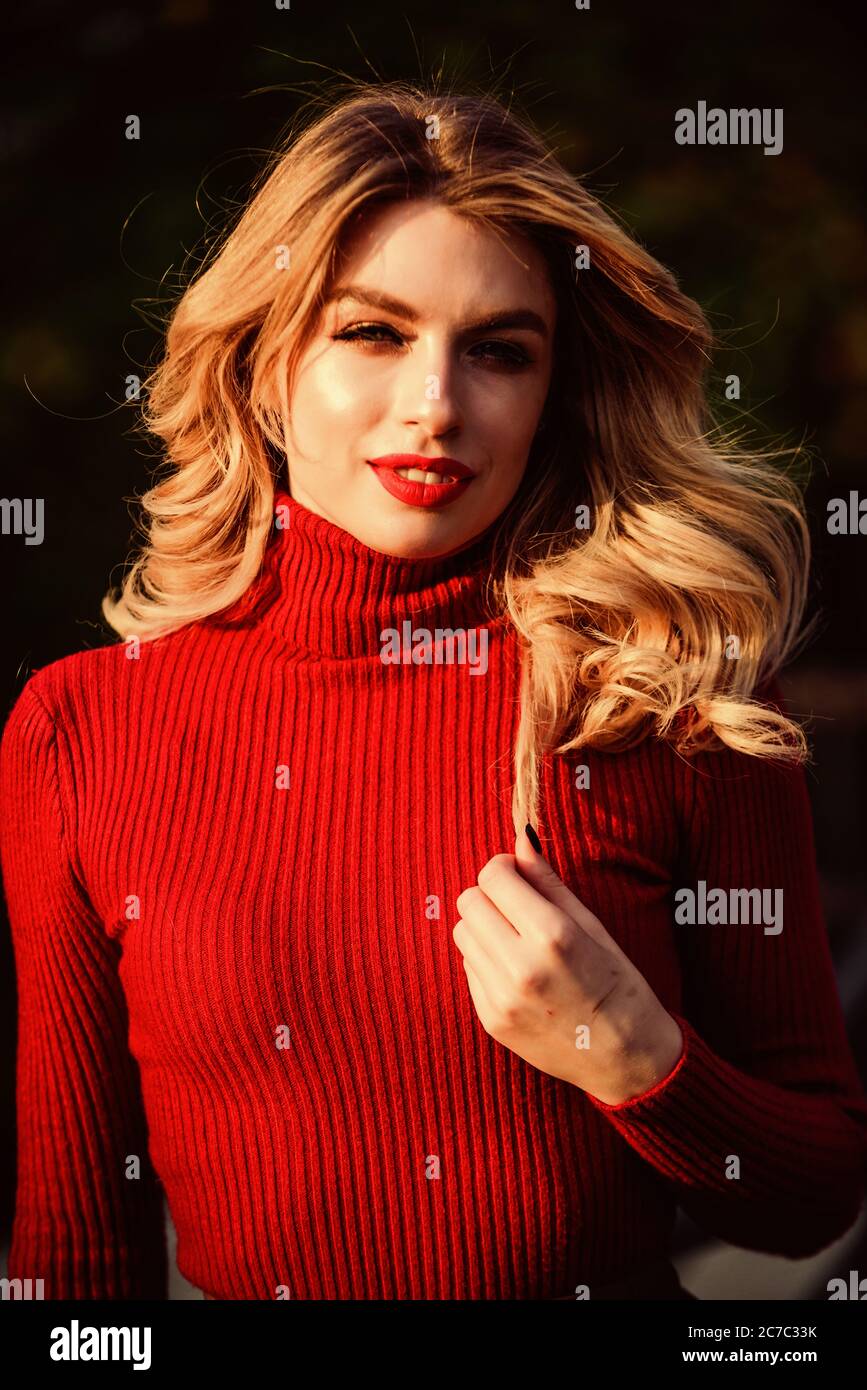 No rush. female beauty. haidresser and makeup. fall fashion season. girl  long blond hair. girl red lipstick in knitwear sweater. cosmetics and skin  care trend. autumn woman curly hair outdoor Stock Photo -