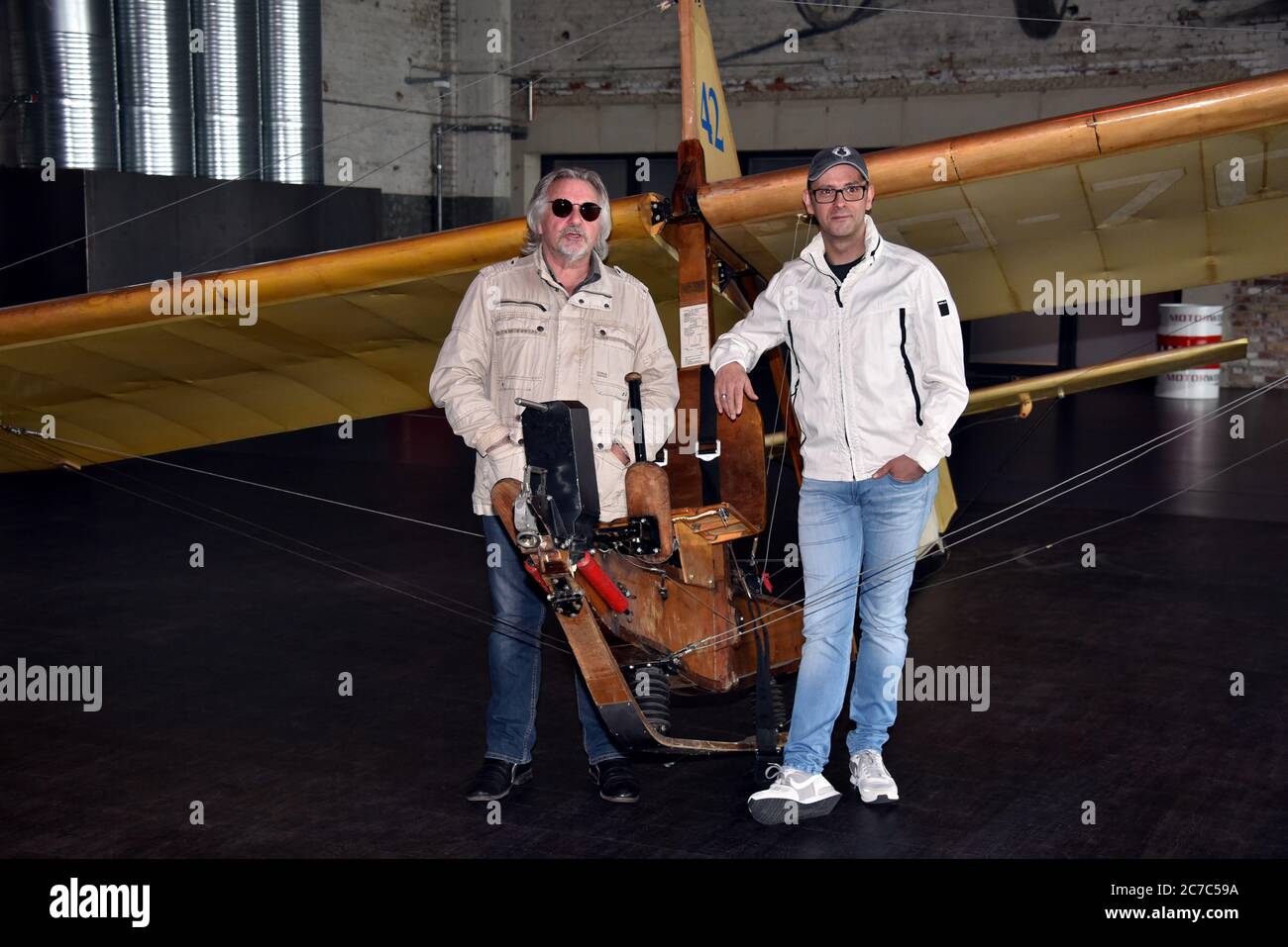 15 July 2020, North Rhine-Westphalia, Cologne: Musician Tommy Engel and comedian Marc Metzger, l-r, pose on a school glider SG 38, glider from 1942, during the presentation of the safety and hygiene concept of the dinner show 'Weihnachtsengel' which will be shown from 20.11.2020. Photo: Horst Galuschka/dpa/Horst Galuschka  dpa Stock Photo