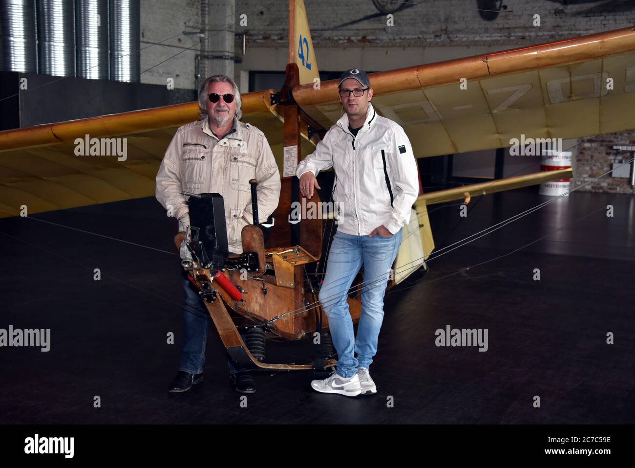 15 July 2020, North Rhine-Westphalia, Cologne: Musician Tommy Engel and comedian Marc Metzger, l-r, pose on a school glider SG 38, glider from 1942, during the presentation of the safety and hygiene concept of the dinner show 'Weihnachtsengel' which will be shown from 20.11.2020. Photo: Horst Galuschka/dpa/Horst Galuschka  dpa Stock Photo