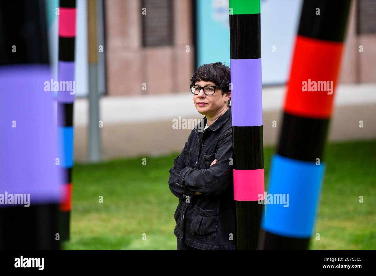 London, UK.  16 July 2020. Major contemporary London-based, Irish artist Eva Rothschild poses at the unveiling of her work 'My World and Your World.  The new 16m high, public sculpture in Lewis Cubitt Park in King's Cross resembles a lightning bolt, painted in black, purple, pink, orange, green and red stripes.  The coronavirus lockdown caused the April 2020 launch to be postponed, but the unveiling has been able to go ahead now that certain lockdown restrictions have been eased by the UK government.  Credit: Stephen Chung / Alamy Live News Stock Photo