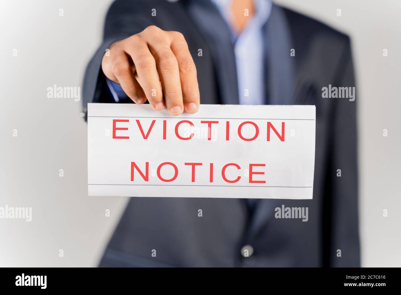 House Landlord or lawyer in suit showing eviction notice on isolated