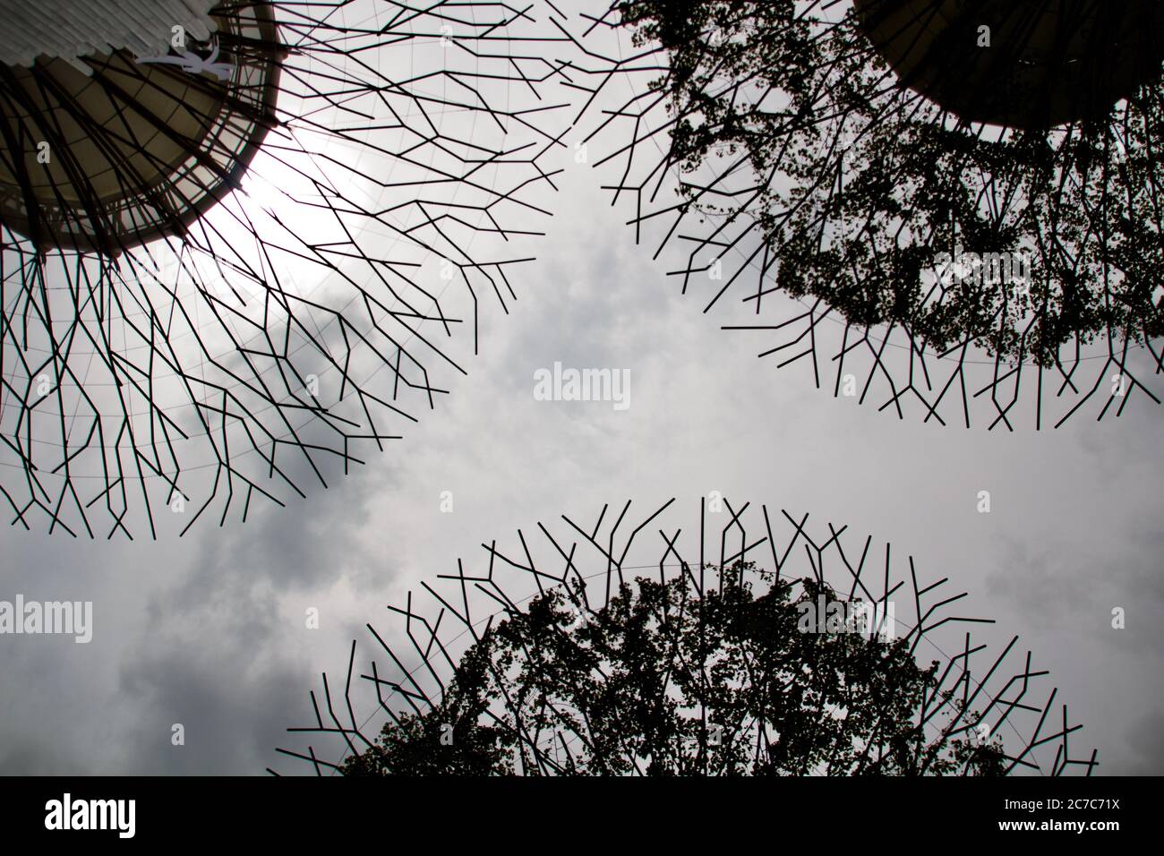 Low shot of metallic tree-like installation in Singapore with grey cloudy sky in the background Stock Photo